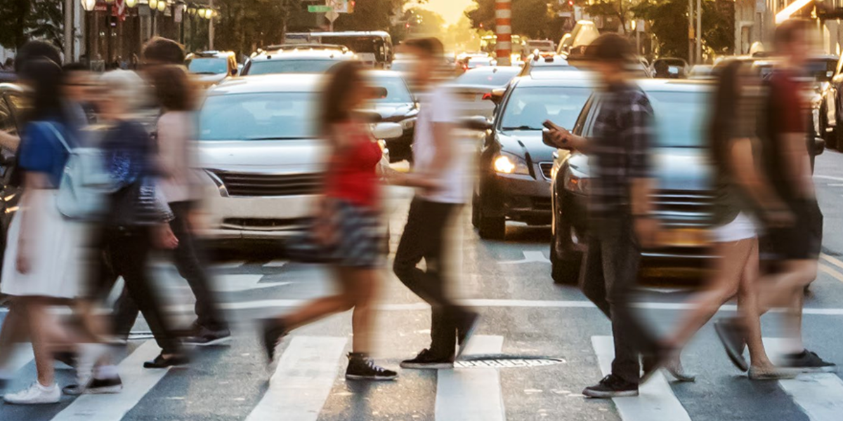 Pedestrians crossing a busy urban street