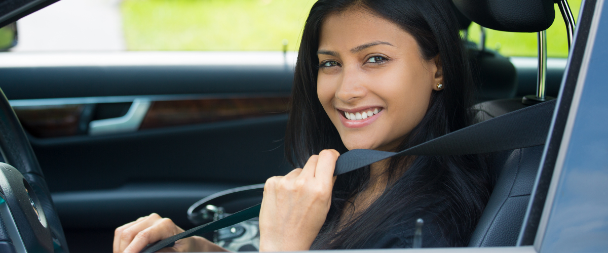 Woman putting her seatbelt on