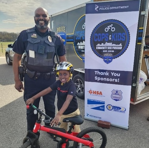 Cop and kid on bike