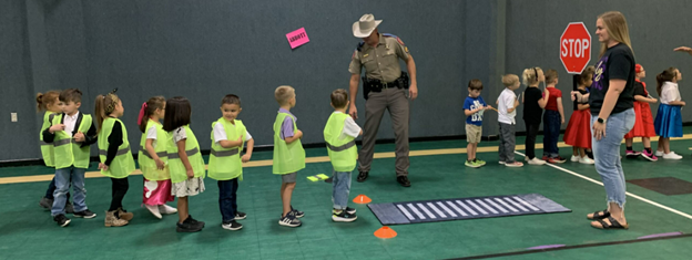 Children standing in a line at a crosswalk