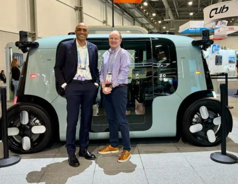 Two men in front of futuristic vehicle