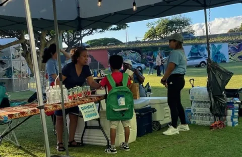 People talking under a tent