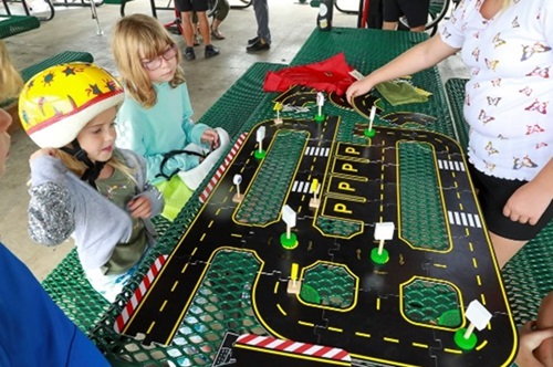 Two children looking at a model road