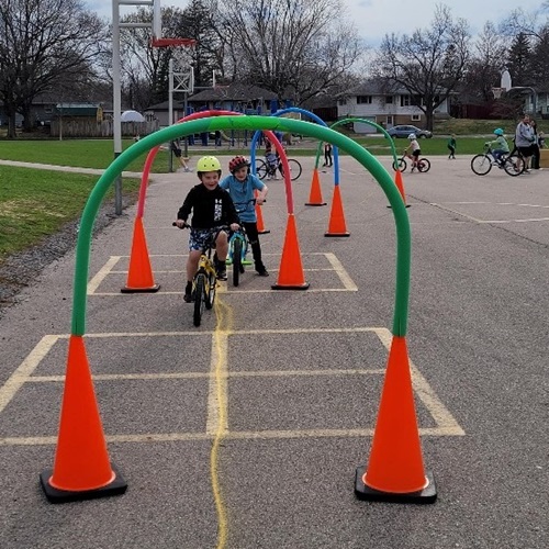 Children riding bicycles through a road course