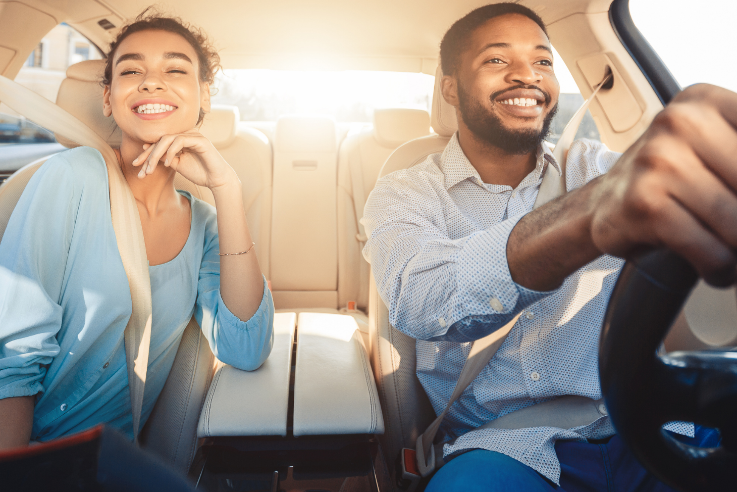 Man and woman smiling in car